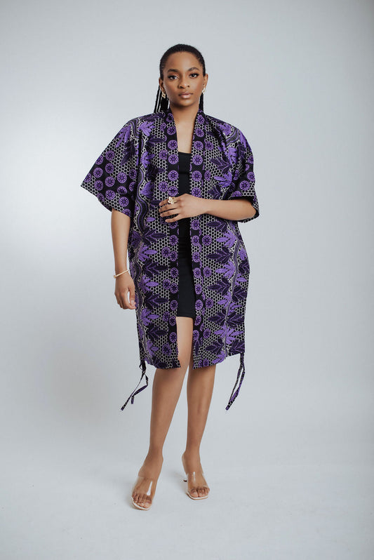 Lady in a black dress and purple African print Kimono
