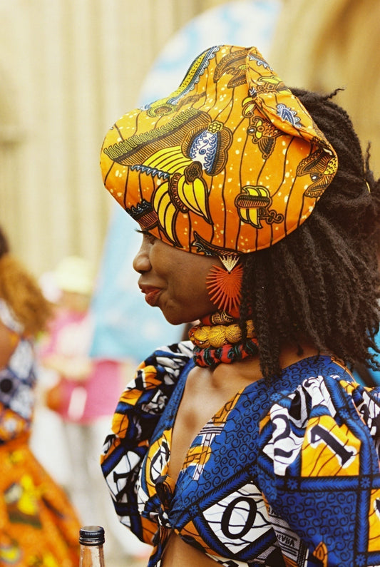 Woman wearing colorful wax-print headwrap and top