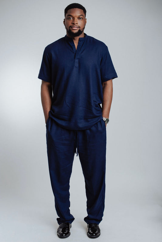 Man wearing a navy blue outfit on a white background