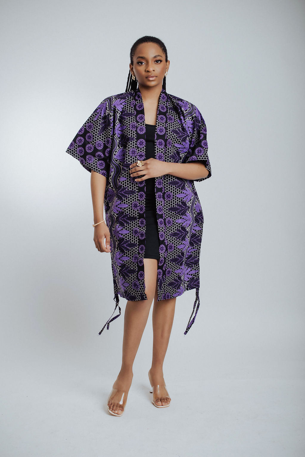 Woman wearing a purple patterned kimono on a white background