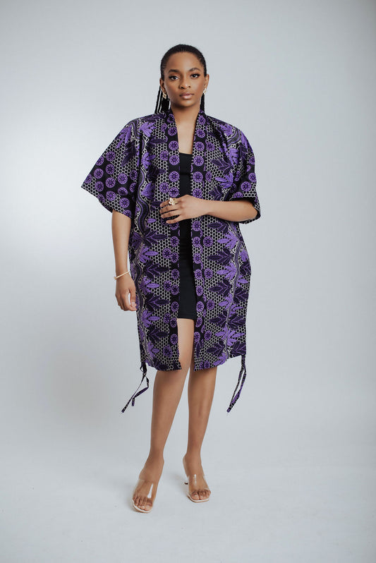 Woman wearing a purple patterned kimono on a white background