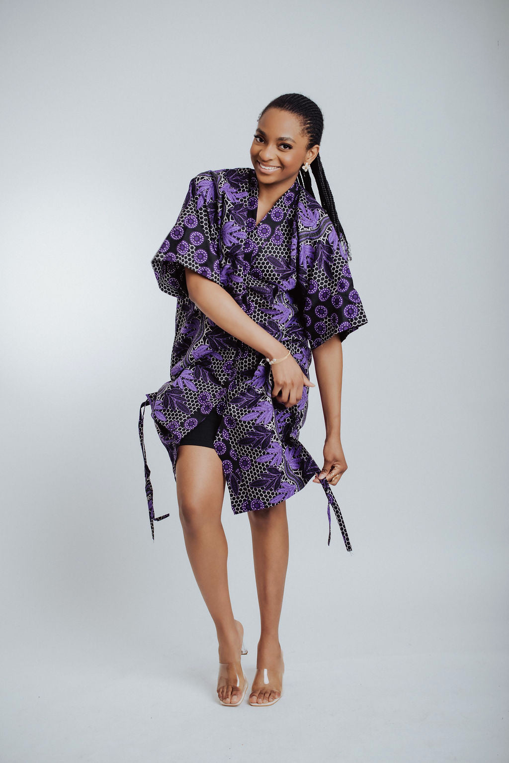 Woman wearing a purple patterned kimono on a white background