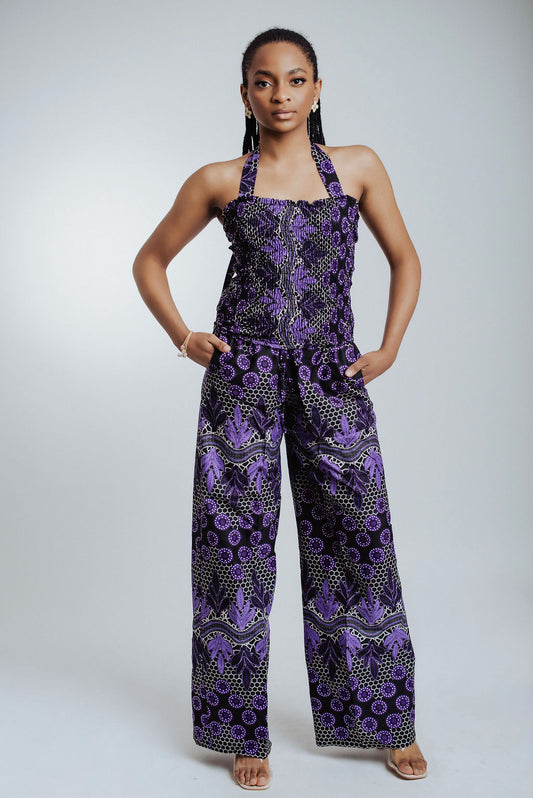 Woman wearing a purple patterned 2 piece set on a white background