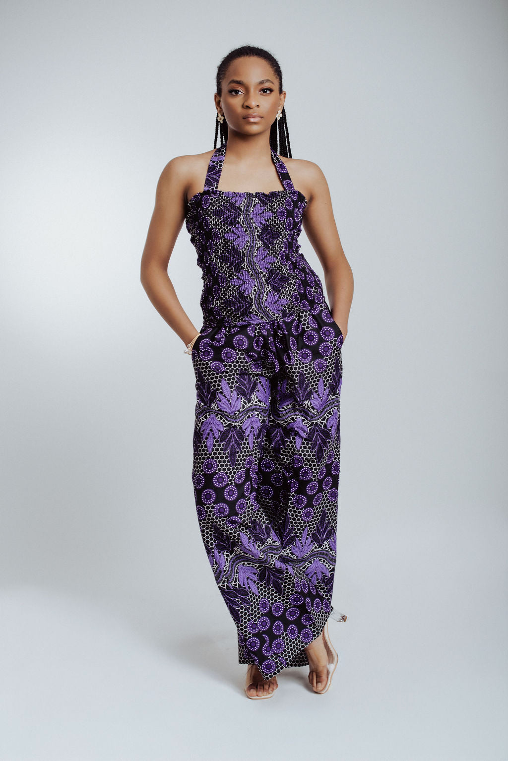 Woman wearing a purple patterned 2 piece set on a white background