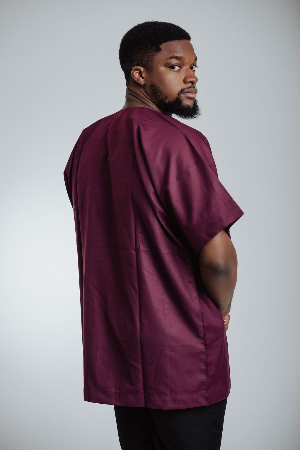 Man wearing a maroon shirt - back view