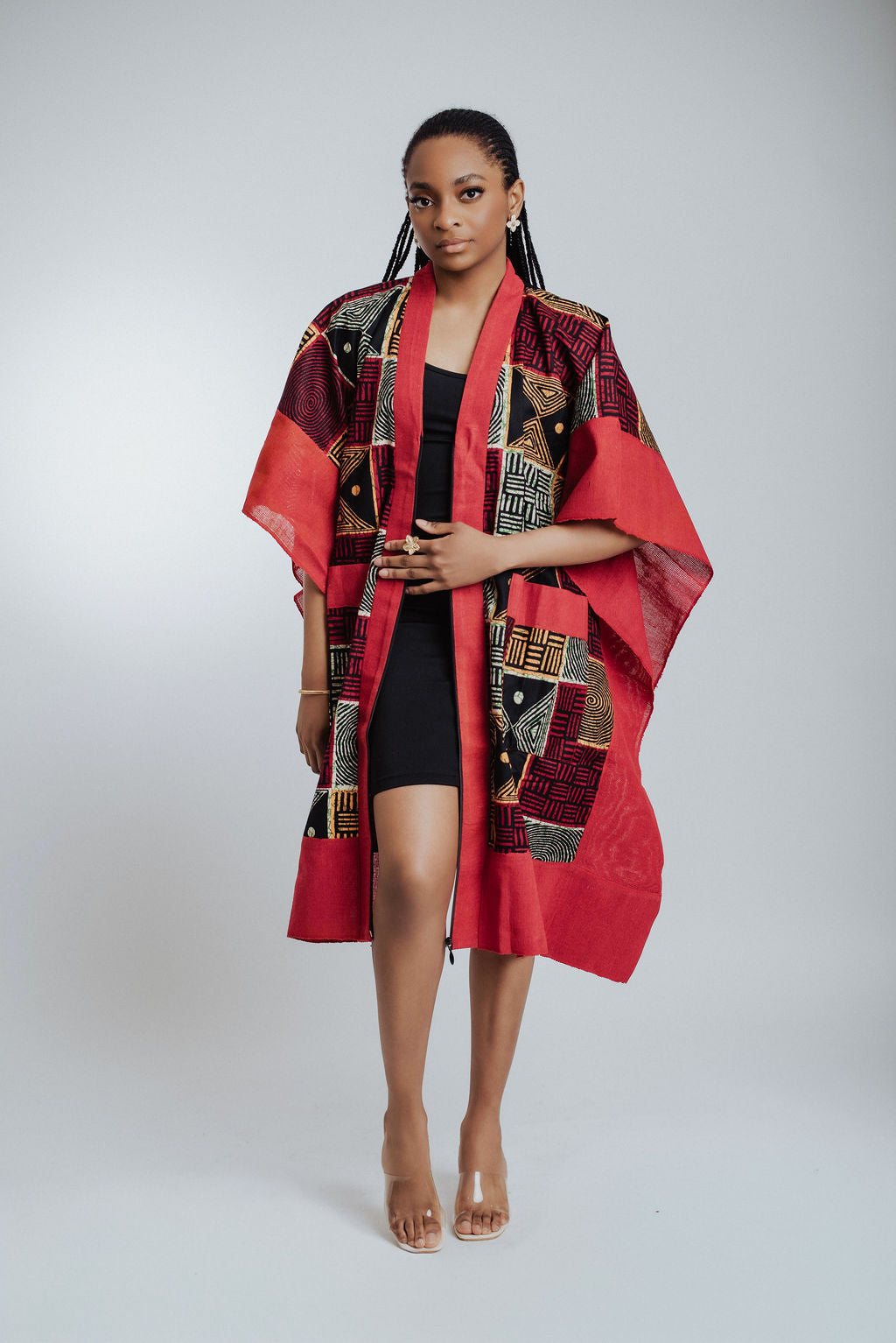 Woman wearing a red and black patterned kimono against a white background