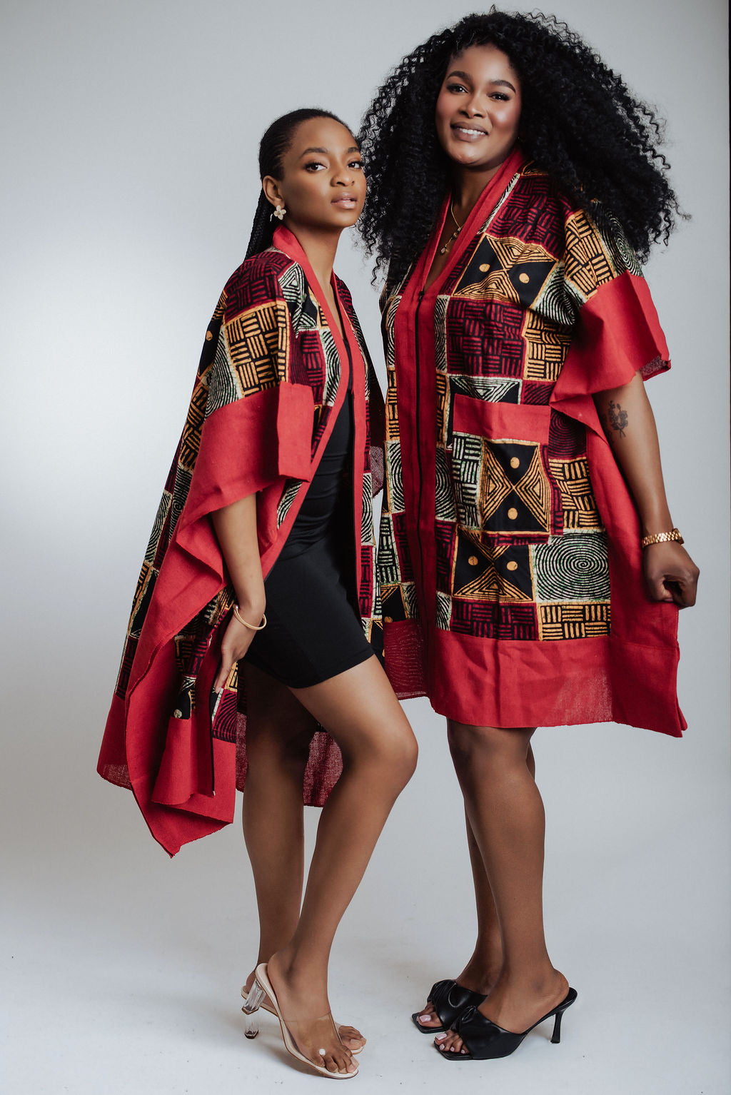 Two women wearing red patterned 2-in-1 dress  and kimono on a white background
